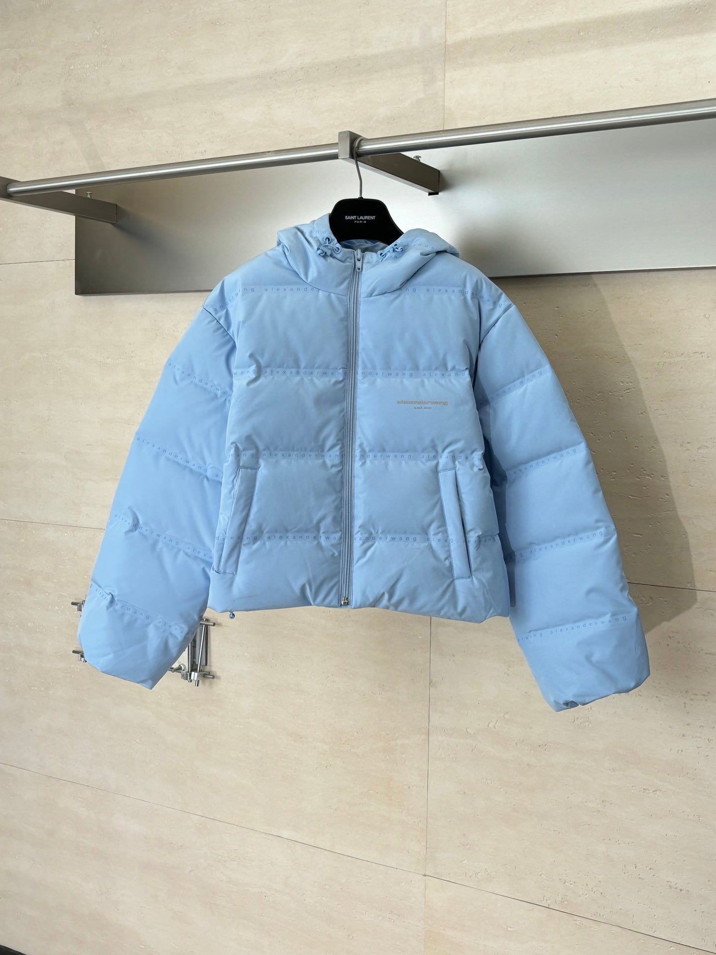Light blue puffer jacket with hood and front zipper