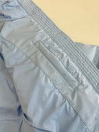Light blue puffer jacket quilted panel with zipper pocket seam