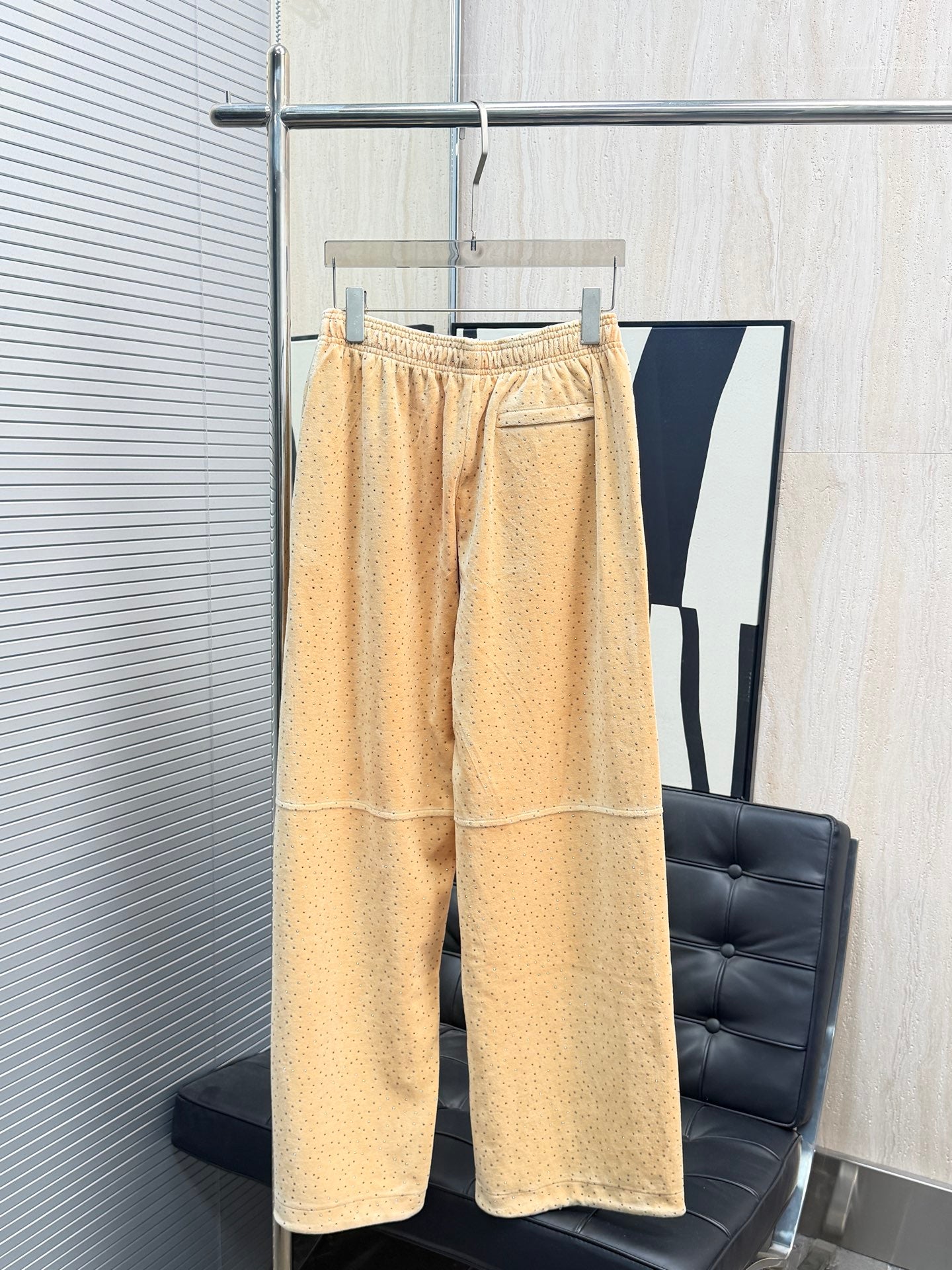 Beige dotted pants with elastic waistband and side seam pockets, wide-leg silhouette
