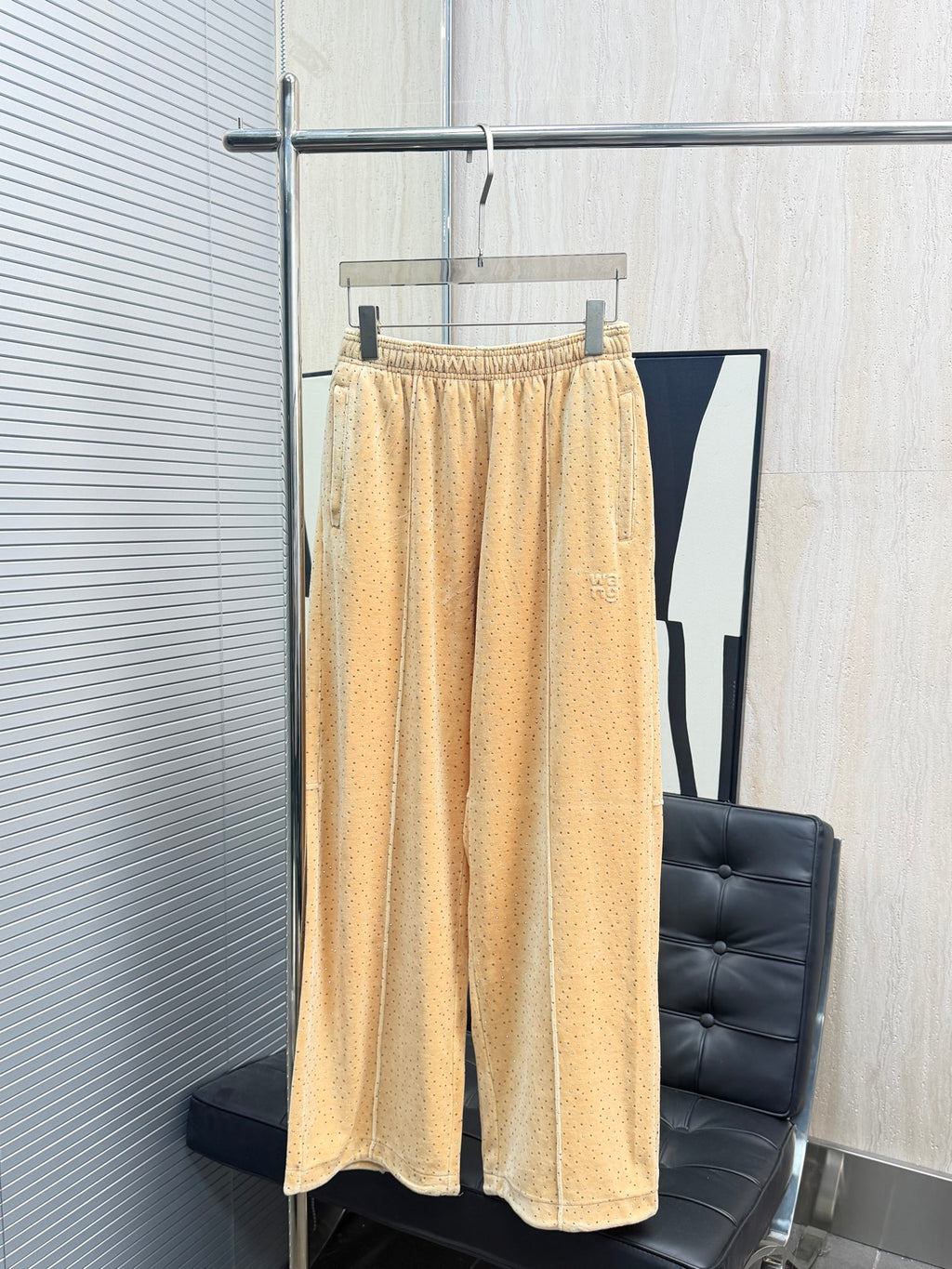 Beige patterned pants with allover tiny dots, elastic waistband, loose wide-leg fit