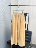 Beige patterned pants with allover tiny dots, elastic waistband, loose wide-leg fit