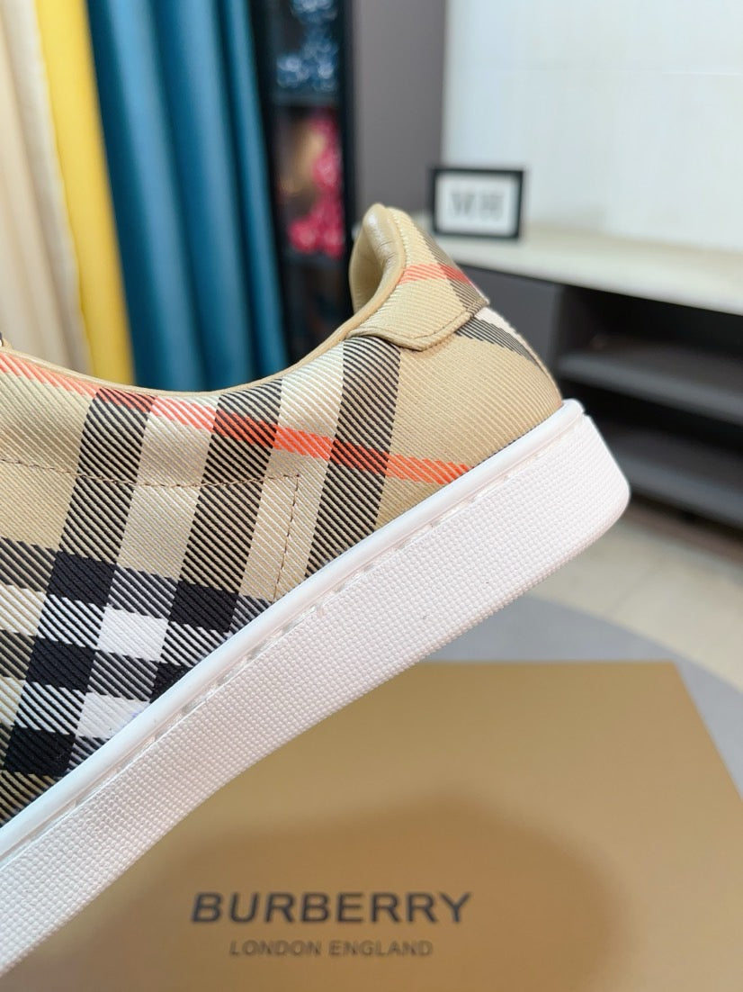 Beige check plaid low-top sneaker with white textured sole and orange-red accent lines