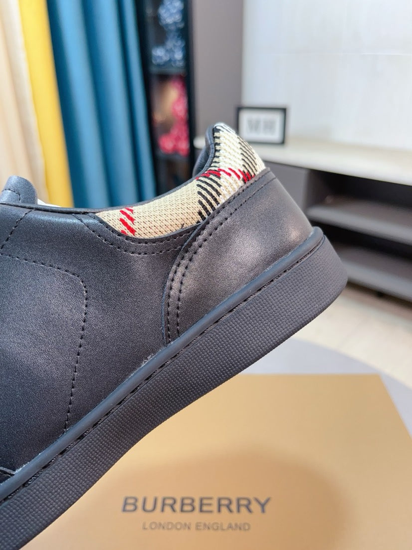 Side view of dark leather low-top sneaker with check-pattern fabric collar