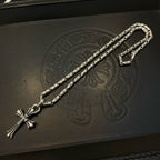 Silver-tone textured chain necklace with cross pendant and lobster clasp ends.