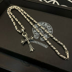Set of two silver-tone cross pendant necklaces with textured link chains.