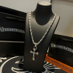 Silver-tone cross pendant necklace with textured link chain and hanging cross charm.