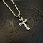 Silver-tone cross pendant with textured link chain, close-up view.