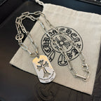 Silver chain necklace with gold-tone dog tag and circular charm on pouch