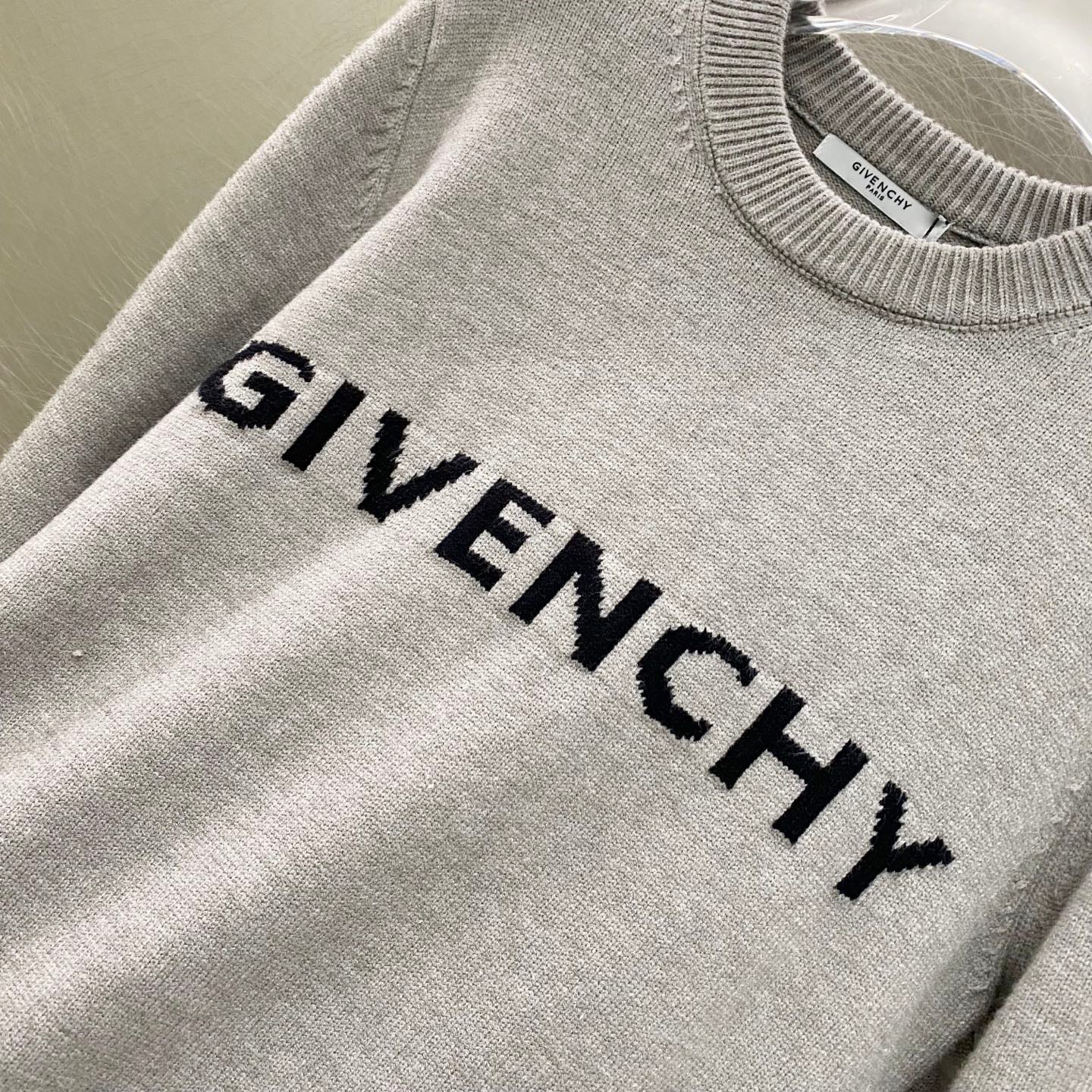 Givenchy knit sweater with "GIVENCHY" lettering across the chest