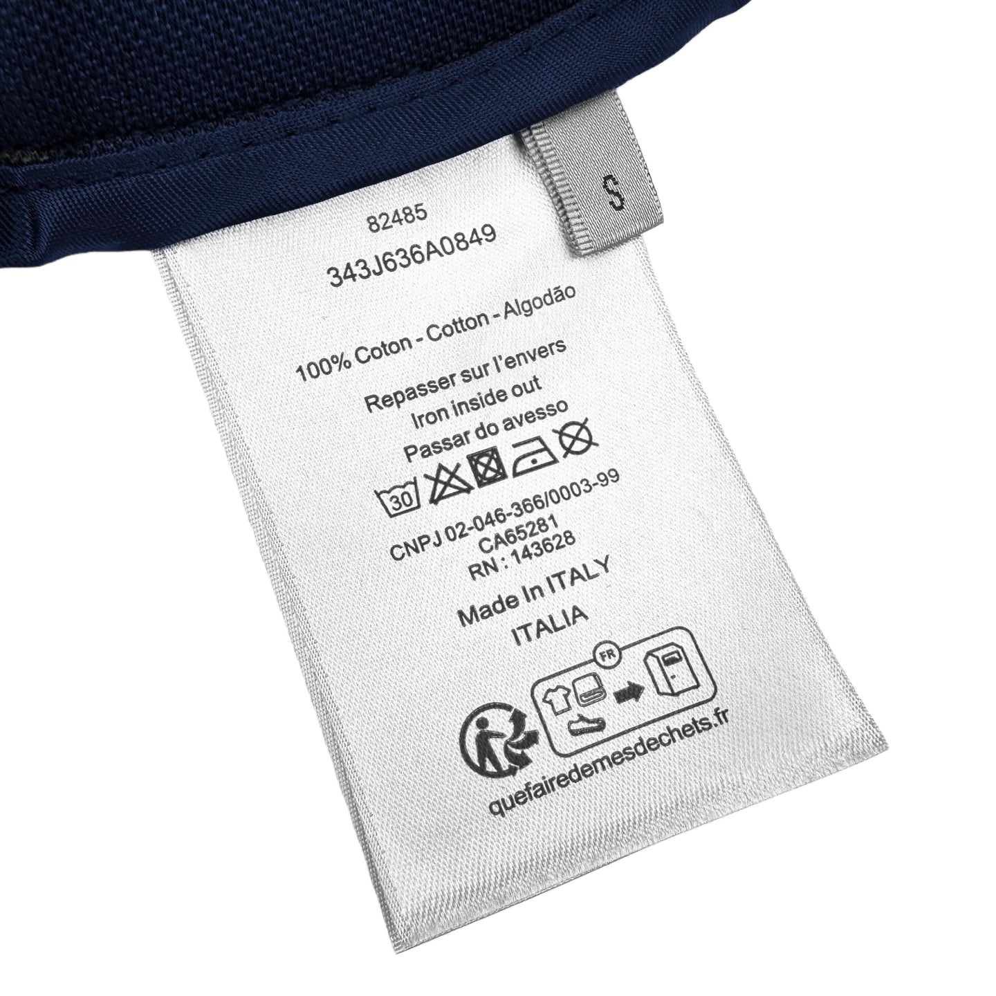 Care label on navy pants: 100% cotton, made in Italy, washing instructions