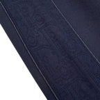 Close-up of navy fabric texture on pants with stitched side seam
