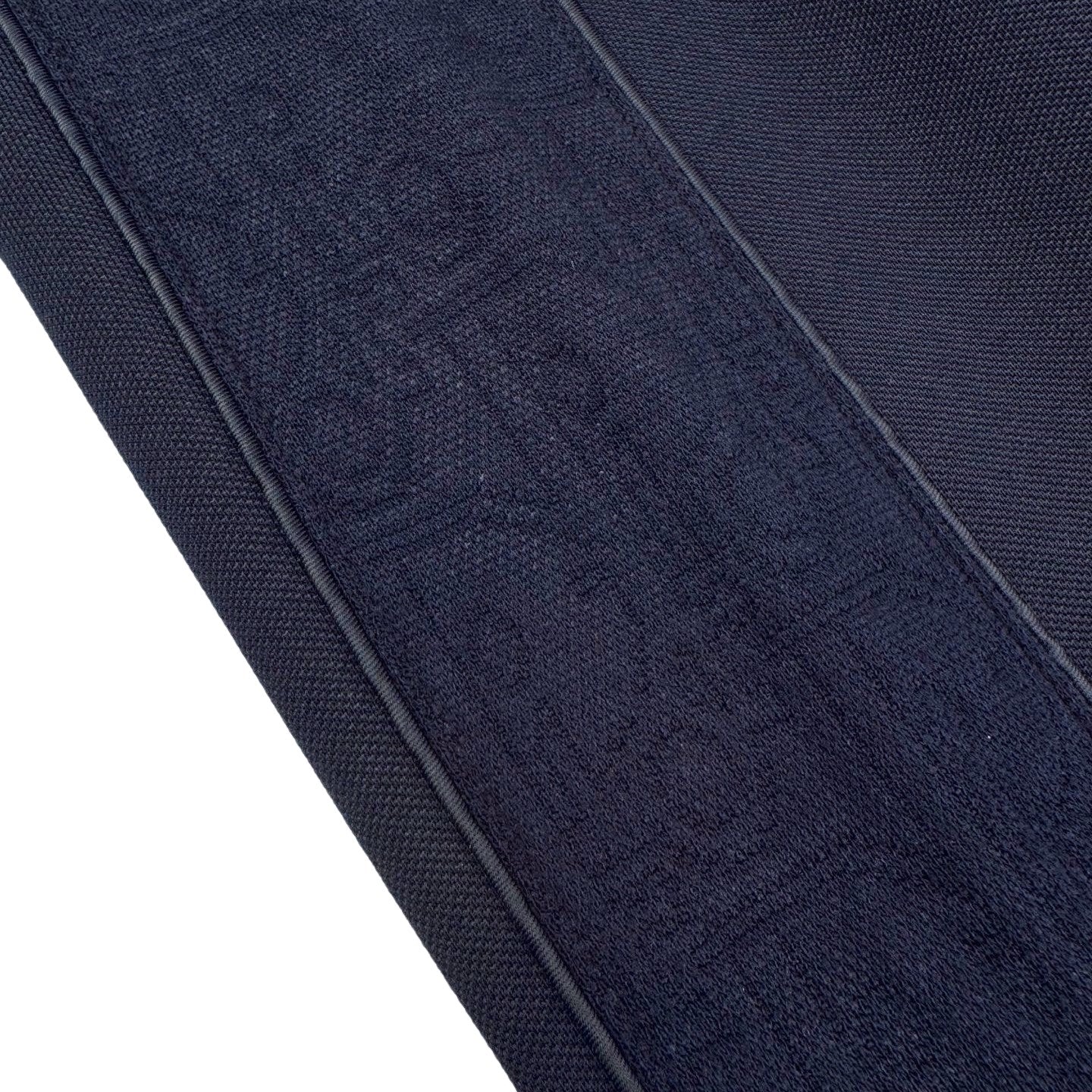 Close-up of navy fabric texture on pants with stitched side seam