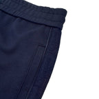 Close-up of navy cuff and waistband with drawstring and seam stitching