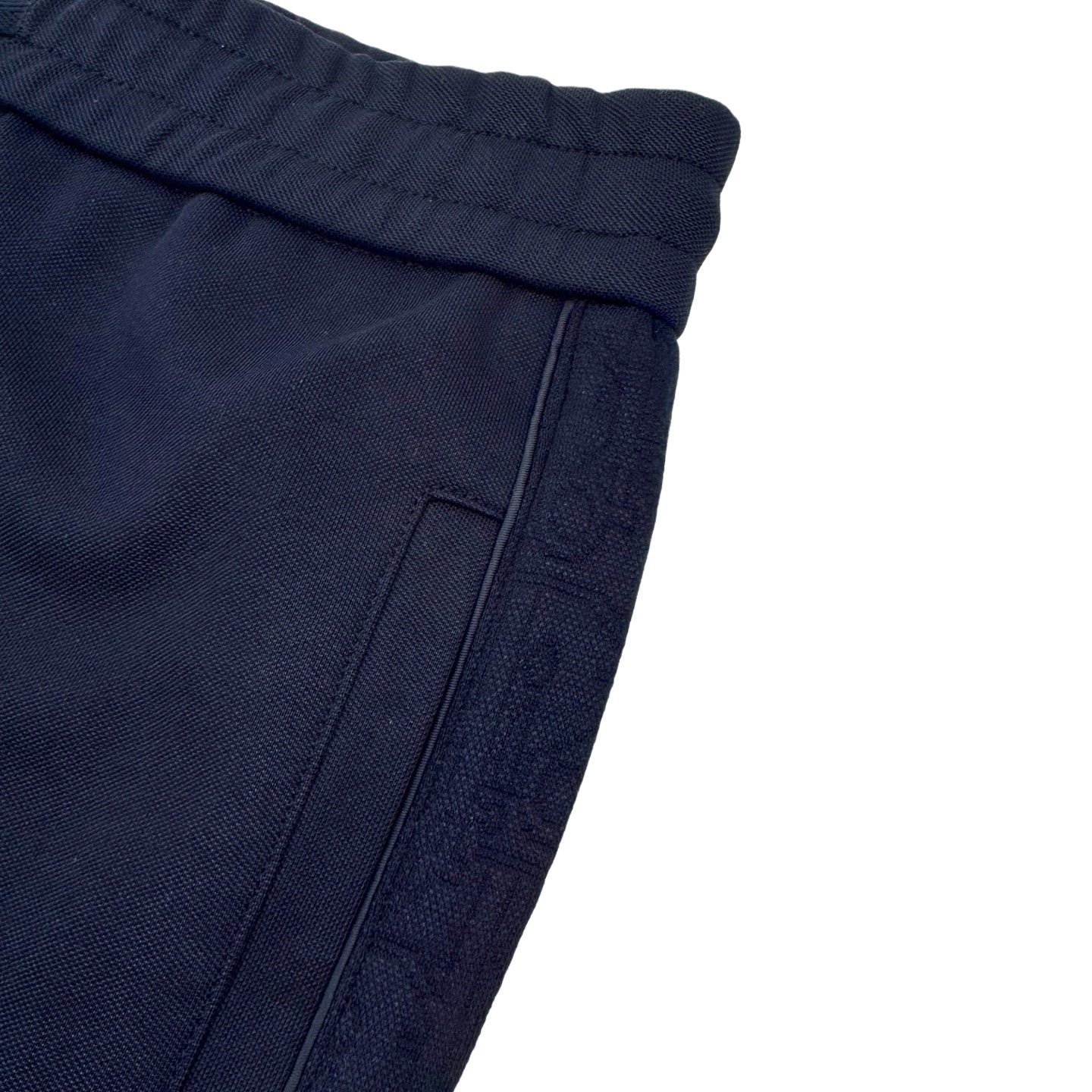 Close-up of navy cuff and waistband with drawstring and seam stitching