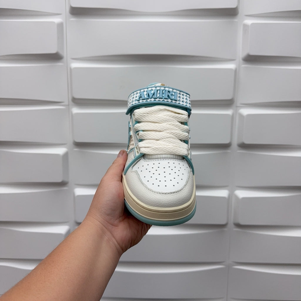 Amiri low-top sneakers, front view with white laces and light blue print collar