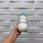 Amiri low-top sneakers, front view with white laces and light blue print collar