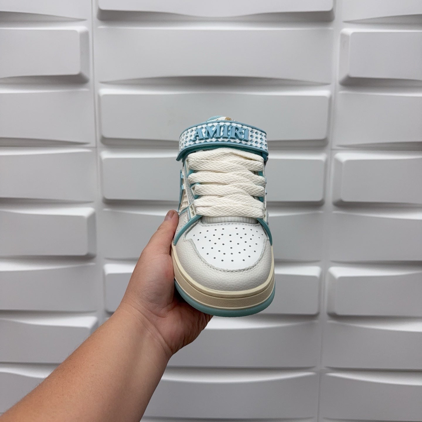 Amiri low-top sneakers, front view with white laces and light blue print collar