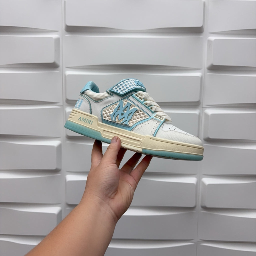Amiri low-top sneakers, side view held up; white with light blue logo strap