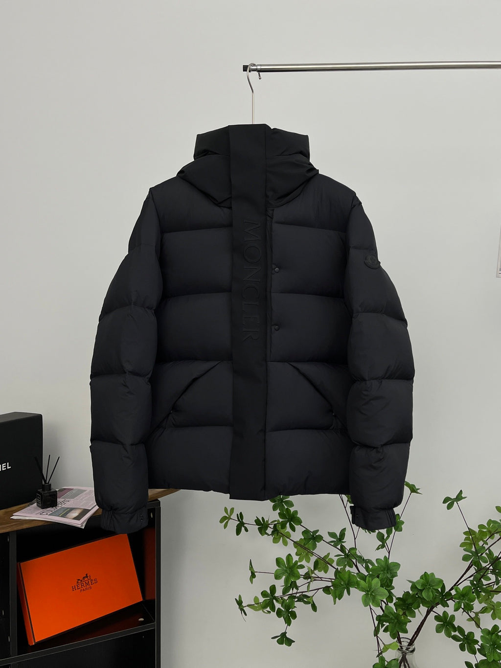 Moncler long hooded puffer jacket, black, front view with quilted paneling
