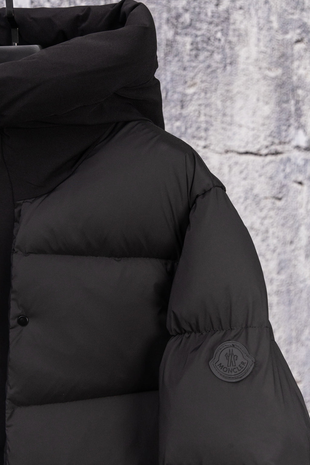 Moncler long puffer jacket, dark, shoulder close-up with sleeve patch