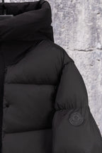 Moncler long puffer jacket, dark, shoulder close-up with sleeve patch