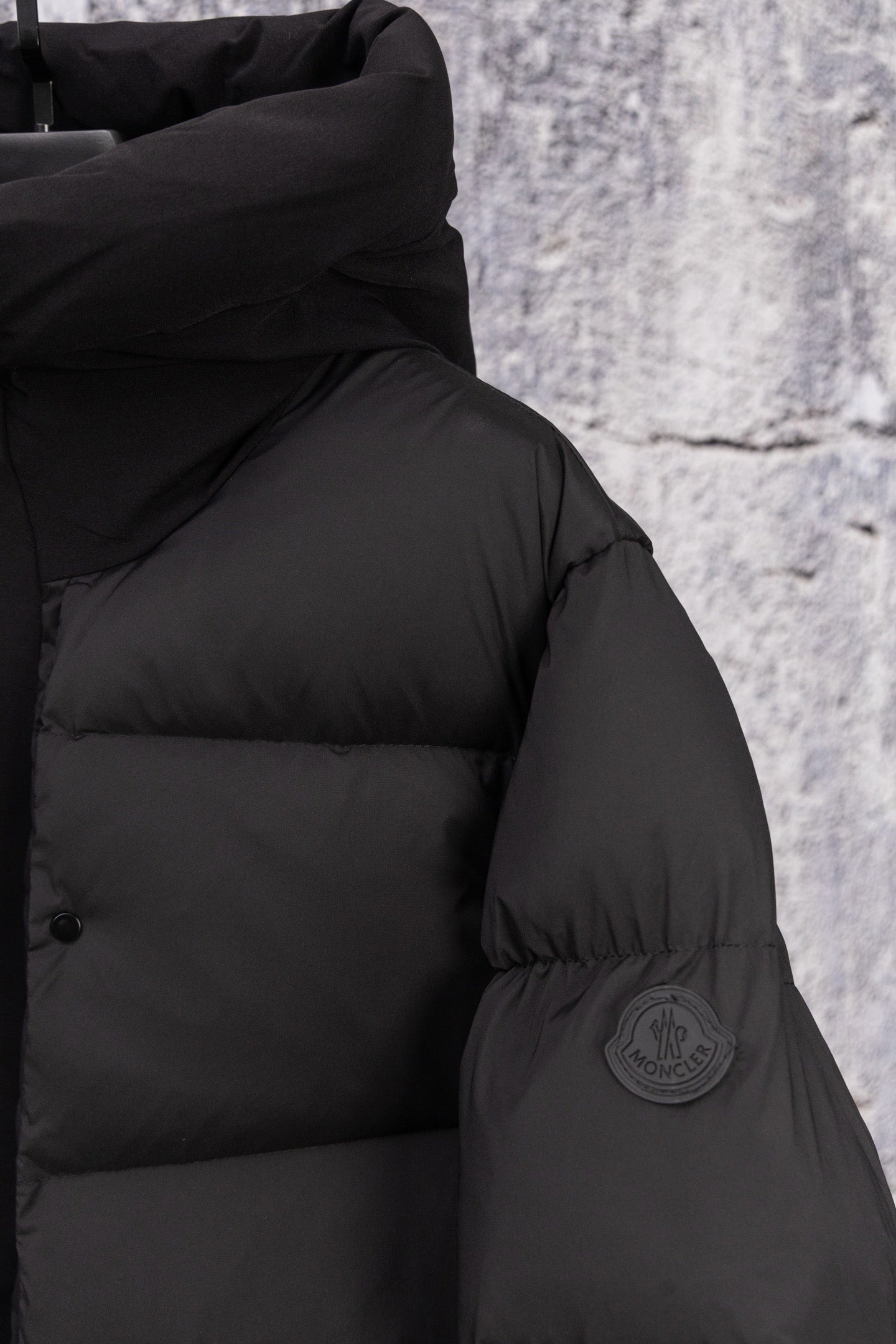 Moncler long puffer jacket, dark, shoulder close-up with sleeve patch