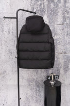Moncler long hooded puffer jacket, dark, hood up on wall display