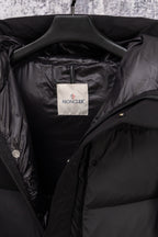 Dark puffer coat interior with Moncler label and open collar lining