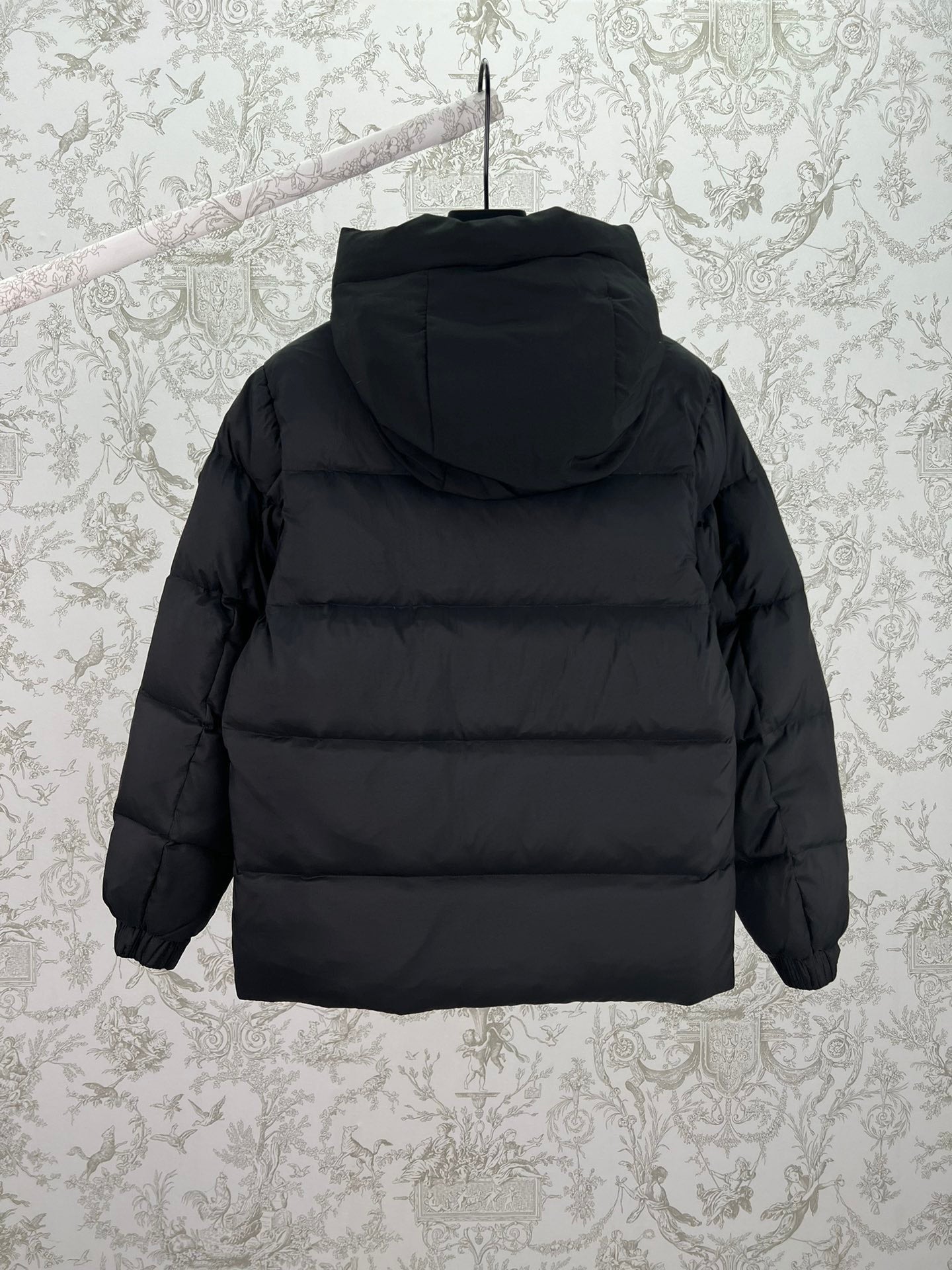 Moncler long hooded puffer jacket, black, back view with hood and front zipper