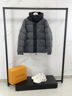 Long puffer jacket with hood, front view, dark gray quilted puffer construction