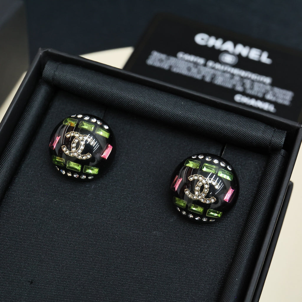 Pair of round Chanel stud earrings with black, green, and pink stone detail