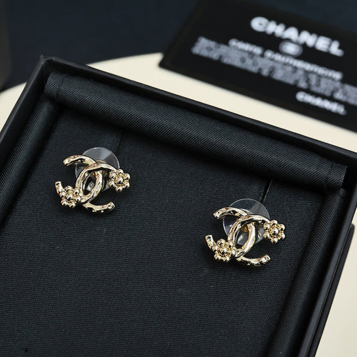 Chanel hoop earrings with gold-tone chain and dark stones, laid in black box