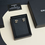 Chanel hoop earrings in black presentation box, gold-tone logo-style motifs