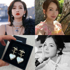 Gold-tone heart drop earrings with pearl-like white heart charms