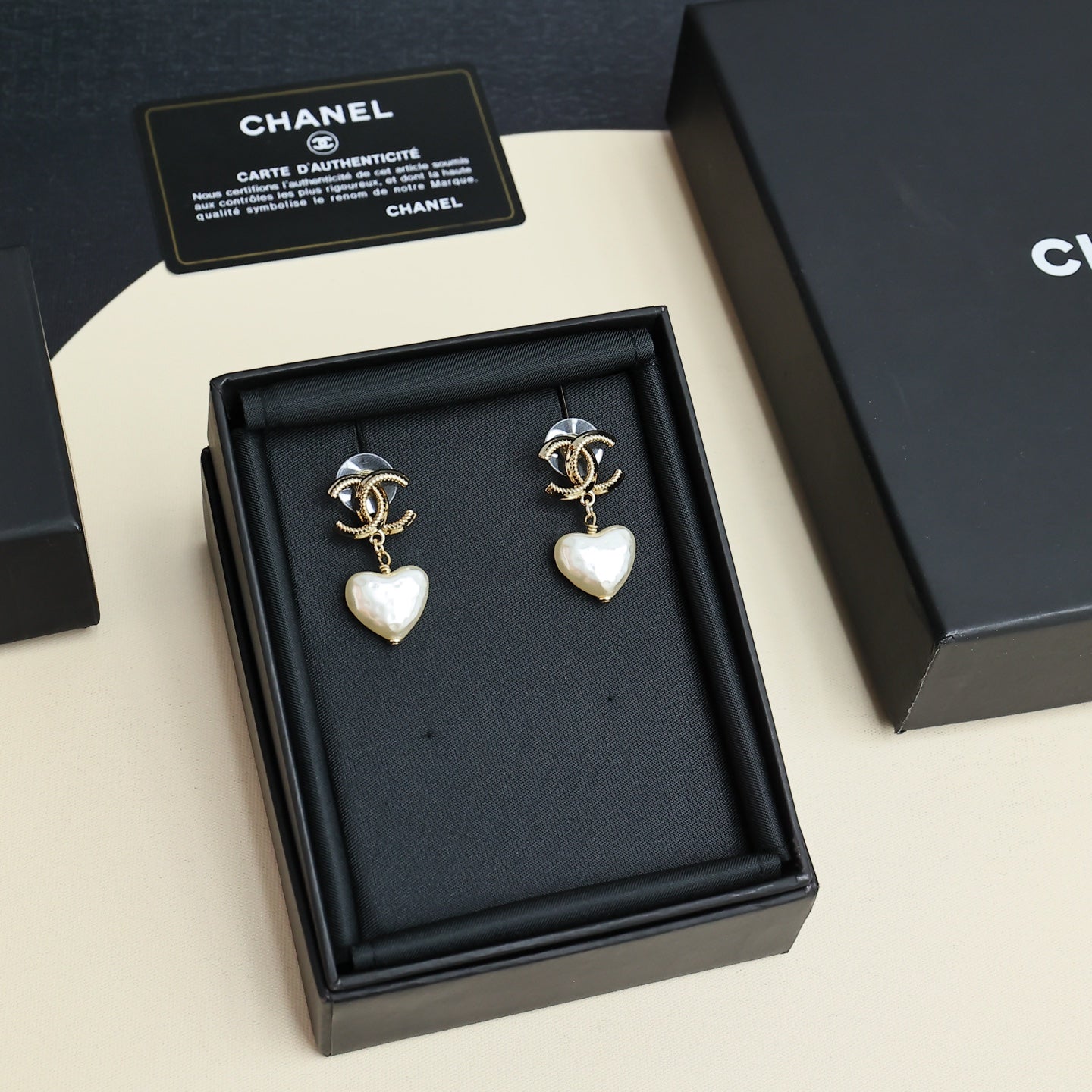 Gold-tone heart drop earrings with pearl-like white heart charms in gift box