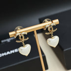 Gold-tone heart drop earrings with pearl-like white heart charms