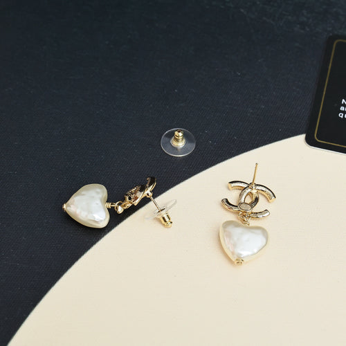 Gold-tone heart earrings with pearl-like white heart dangles
