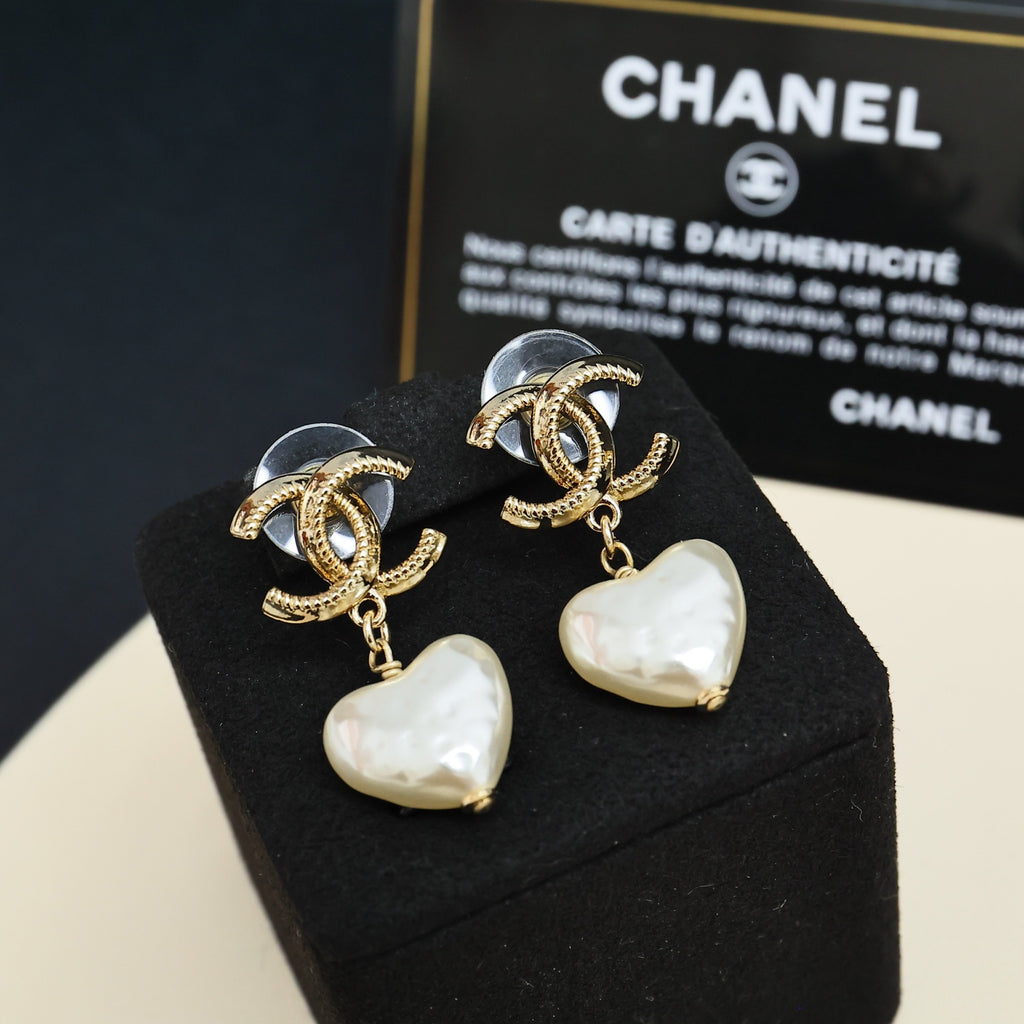 Gold-tone heart drop earrings with pearl-like white heart charms