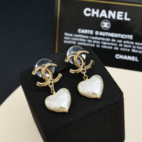 Gold-tone heart drop earrings with pearl-like white heart charms