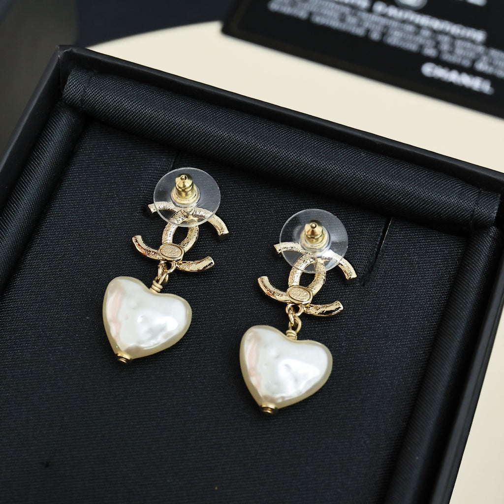 Gold-tone heart drop earrings with pearl-like white heart charms