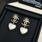 Gold-tone heart drop earrings with pearl-like white heart charms