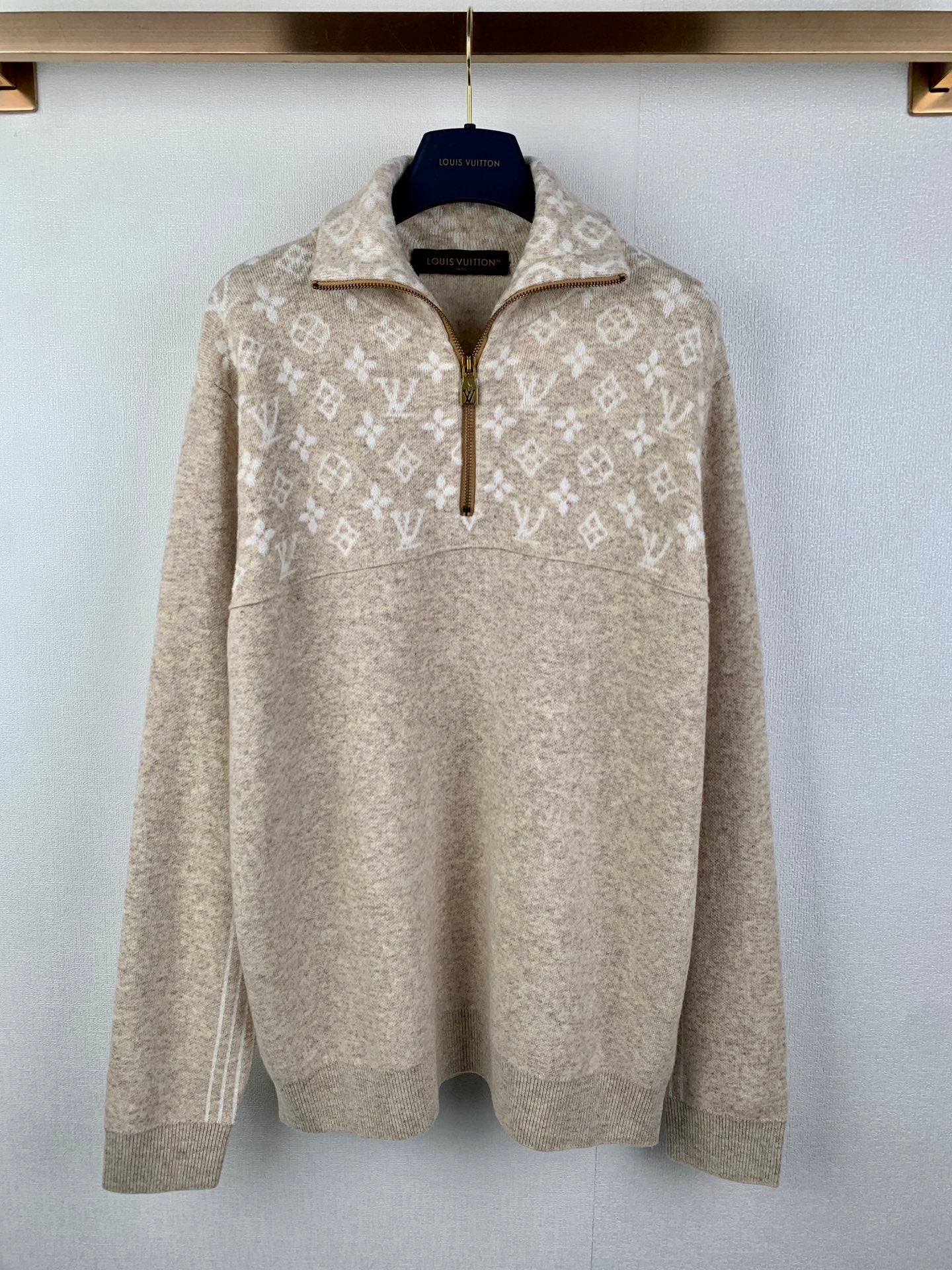 Long-sleeve zip sweater in light beige with repeating monogram pattern, stand collar