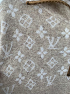 Beige knit sweater with repeating monogram print all over the body