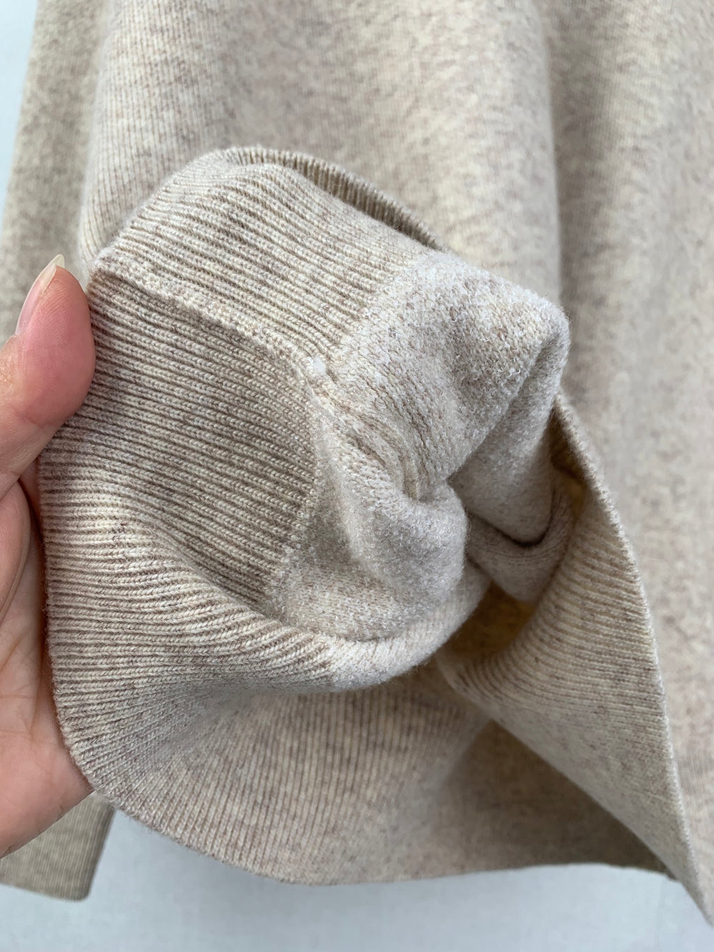 Knit sweater hooded collar drape in light beige, ribbed trim visible
