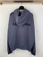 Balenciaga hooded sweatshirt with front zipper, dark blue, and large chest logo