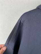 Dark blue zip-up hoodie sleeve and shoulder seam detail
