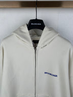 Cream zip-up hoodie with hood and blue BALENCIAGA logo on left chest