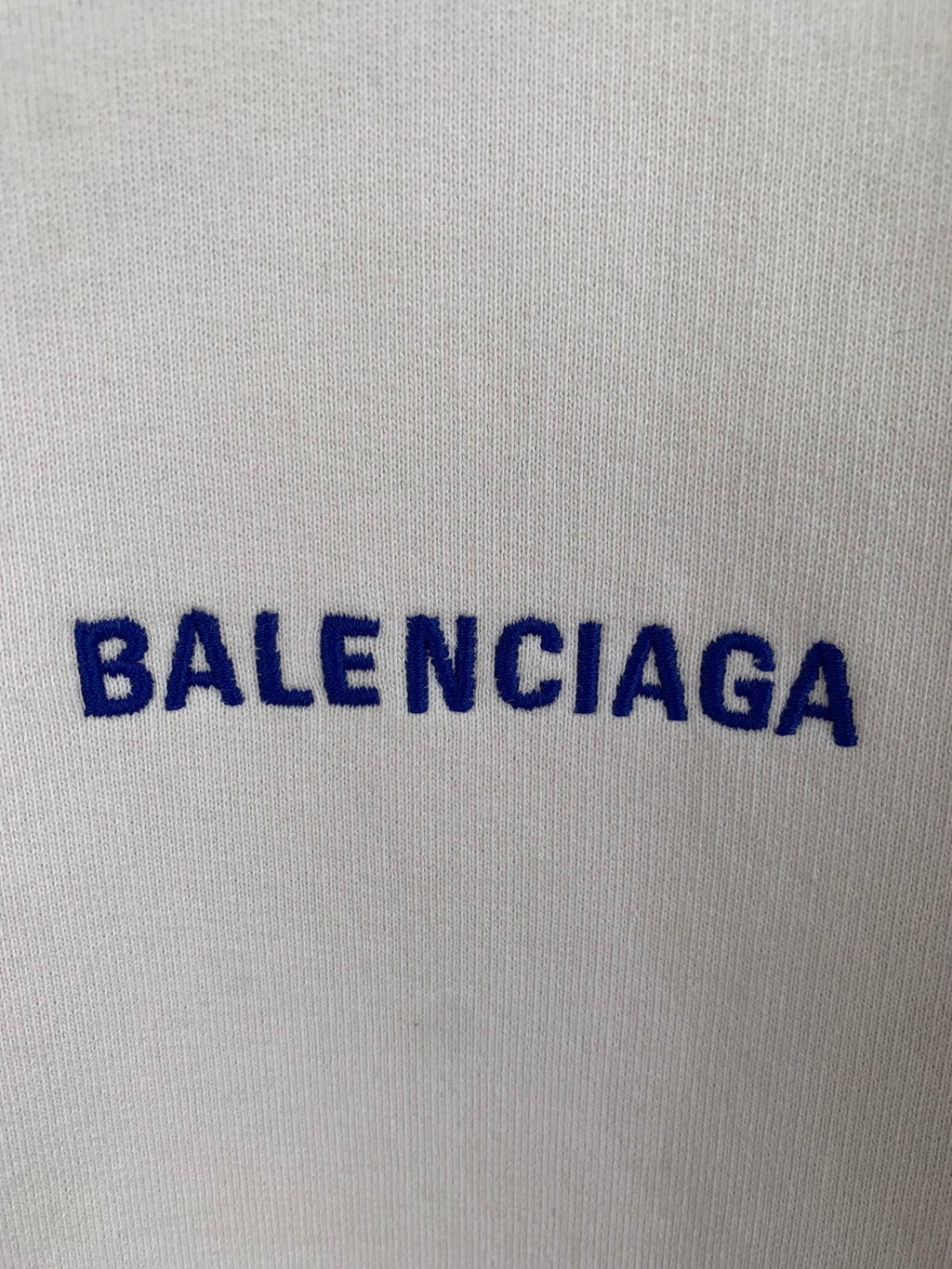 Cream hoodie fabric with blue BALENCIAGA lettering