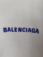 Cream hoodie fabric with blue BALENCIAGA lettering