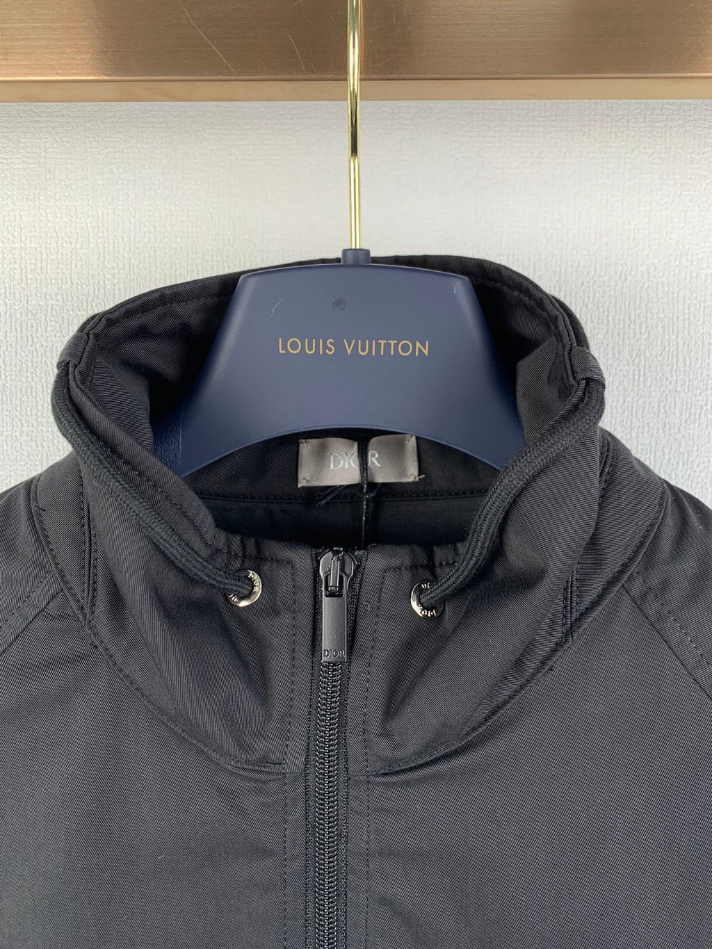 Dior hooded zip jacket with chin guard and adjustable draw cords at hood